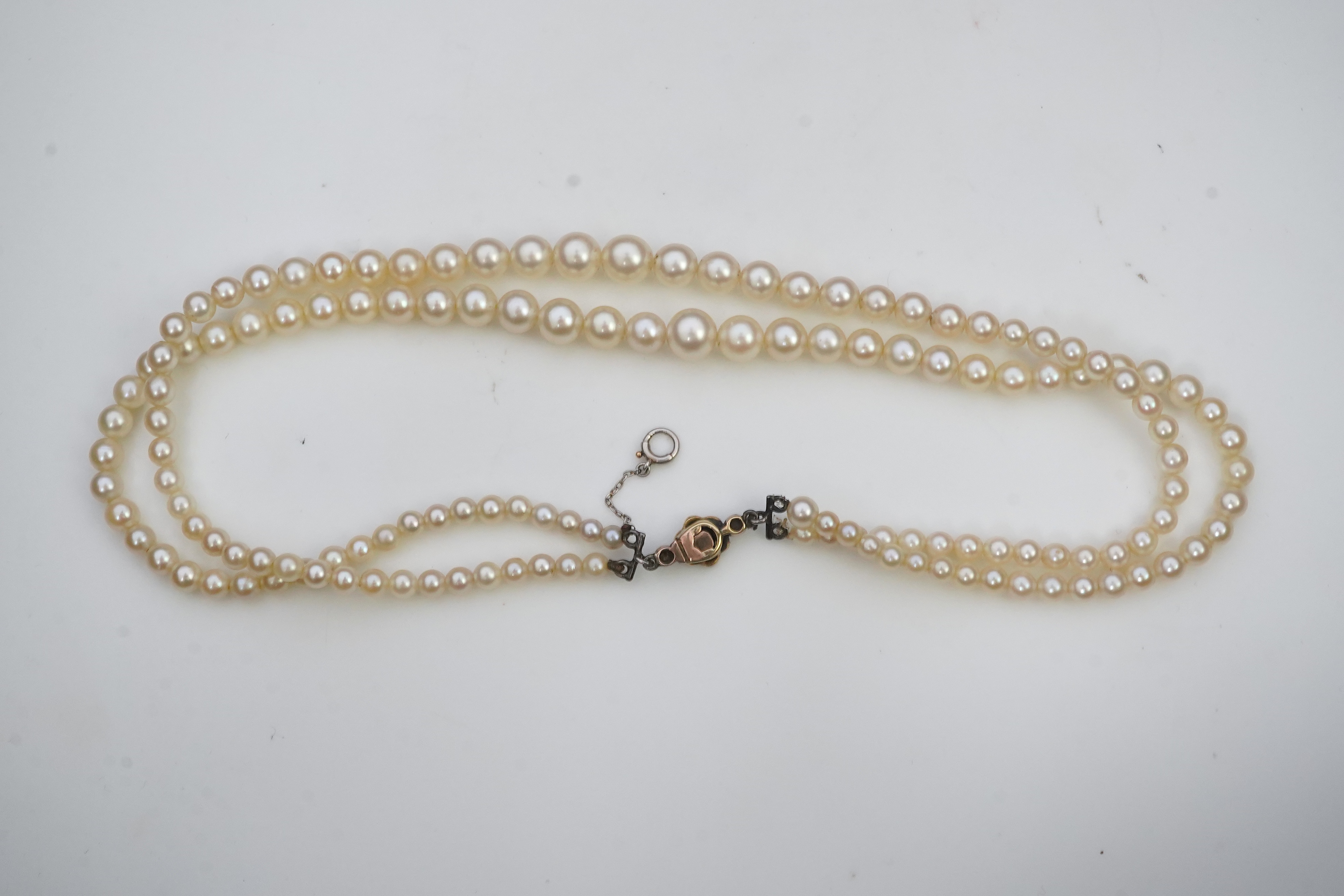 A cultured pearl and diamond necklace, early 20th century and later